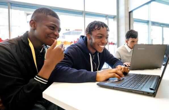 A trio of students working on laptops
