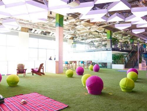An indoor park with pink and green tennis balls at Plexal