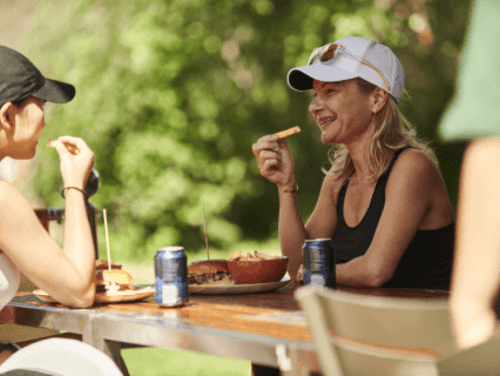 Two people eating outside of Timber Lodge Cafe