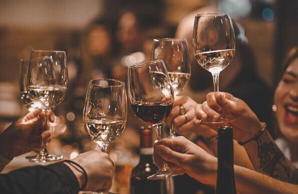 A group of people toast with wine glasses at Barge East