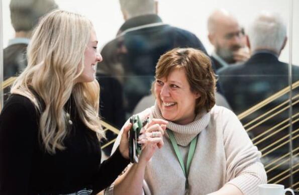 Two women laughing during a networking event at Plexal