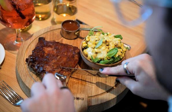 Dinner at Haugen with a wooden board with steak and mac and cheese side