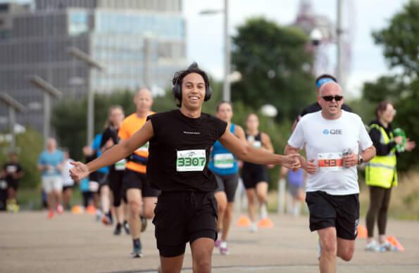 a runner runs through the Queen Elizabeth Olympic Park