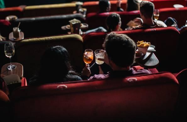 People sat in a cinema screen with food and drink