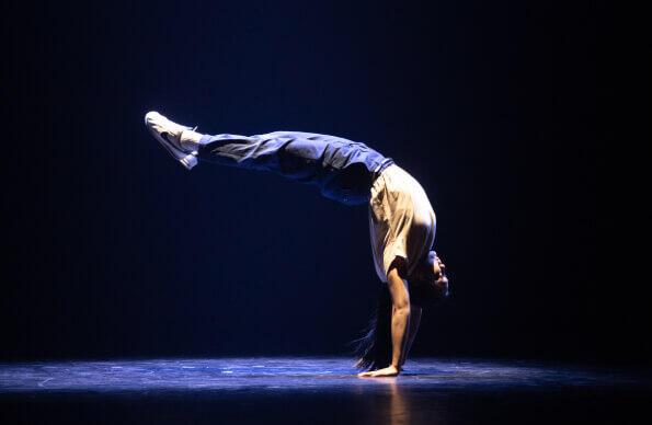 A dancer performs a handstand and backbend