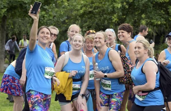 A group of women pose for a selfie at a RunThrough event at Queen Elizabeth Olympic Park