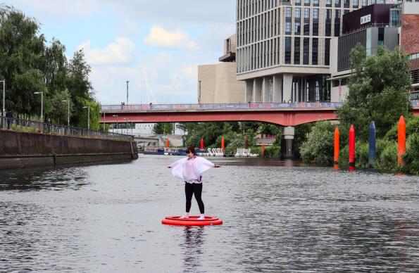 A participant of Discosailing floats down the river at Queen Elizabeth Olympic Park