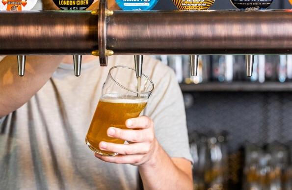 A beer being poured by a bar person at The Lock Inn