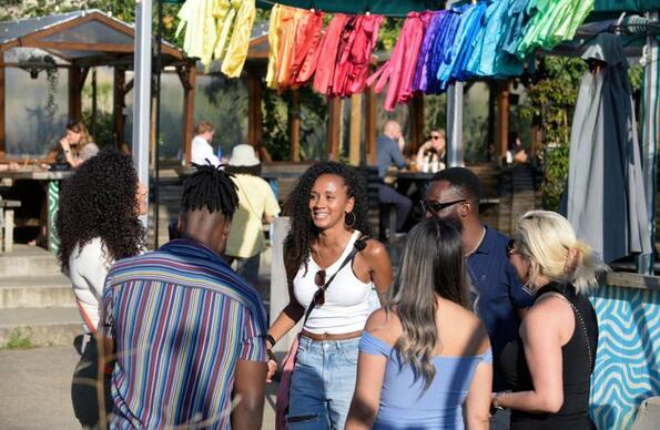 A group of people socialising at Barge East on Queen Elizabeth Olympic Park