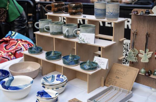 a selection of pottery on sale at a market