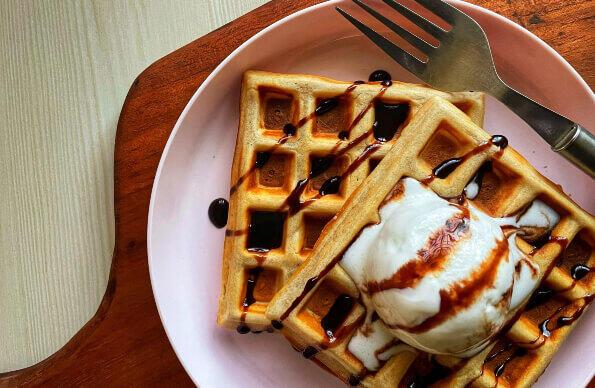 Two dessert waffles with ice cream.