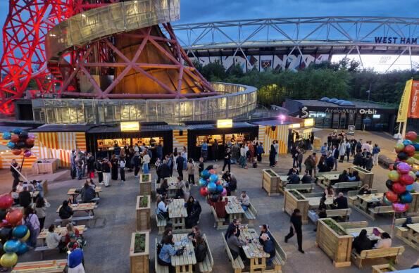 The opening of Riverside East with groups of people round tables