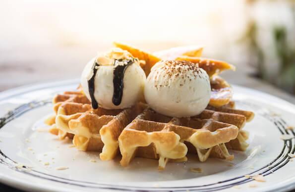 Waffles with vanilla ice cream and maple syrup