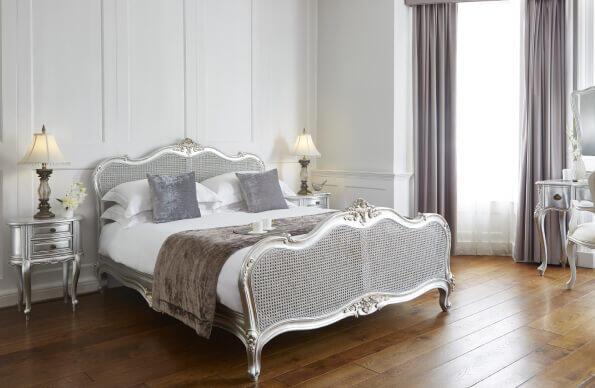 A room at the Westbridge Hotel with wooden floors and large bed