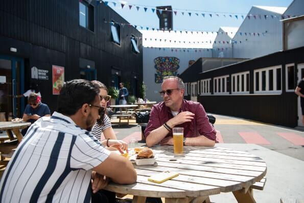 People eating outside Hackney Bridge