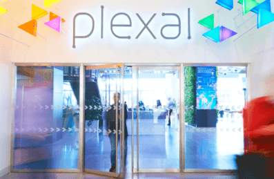 A blur of people walking through the colourful Plexal entrance