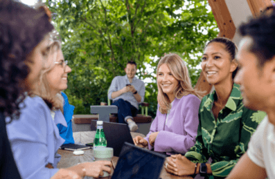 A group of people having a meeting outside