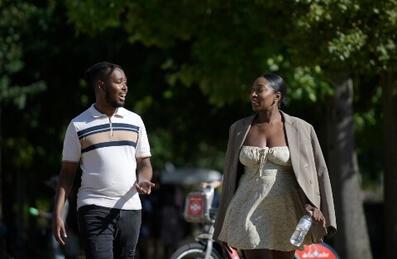 Two people walking and talking outside